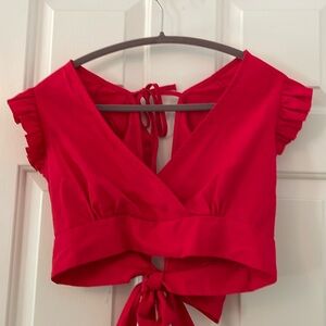 Red cotton crop top with ruffled sleeves and bow ties in back.  Size XL